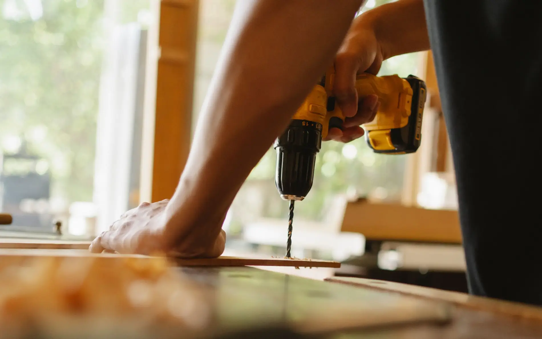 Handyman drilling a timber project